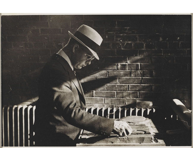 Richard Plumb carving a clay model of mounded circles c. 1940. Designs for new plots that followed the pre-World War II pattern of large circles were revised to accommodate smaller repetitive lots after the war. Avery Library, Drawings & Archives, Woodlawn Cemetery Records. Photo of Richard Plumb